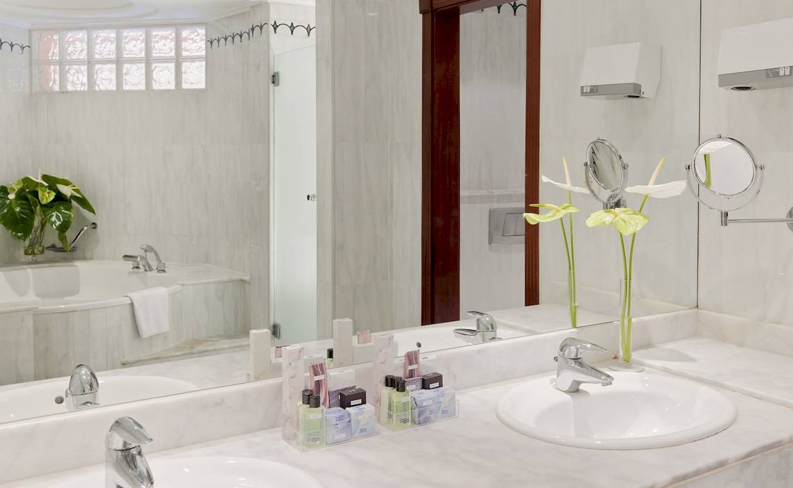 Badezimmer des H10 Playa Meloneras Palace Hotels mit Badewanne und Waschbecken.