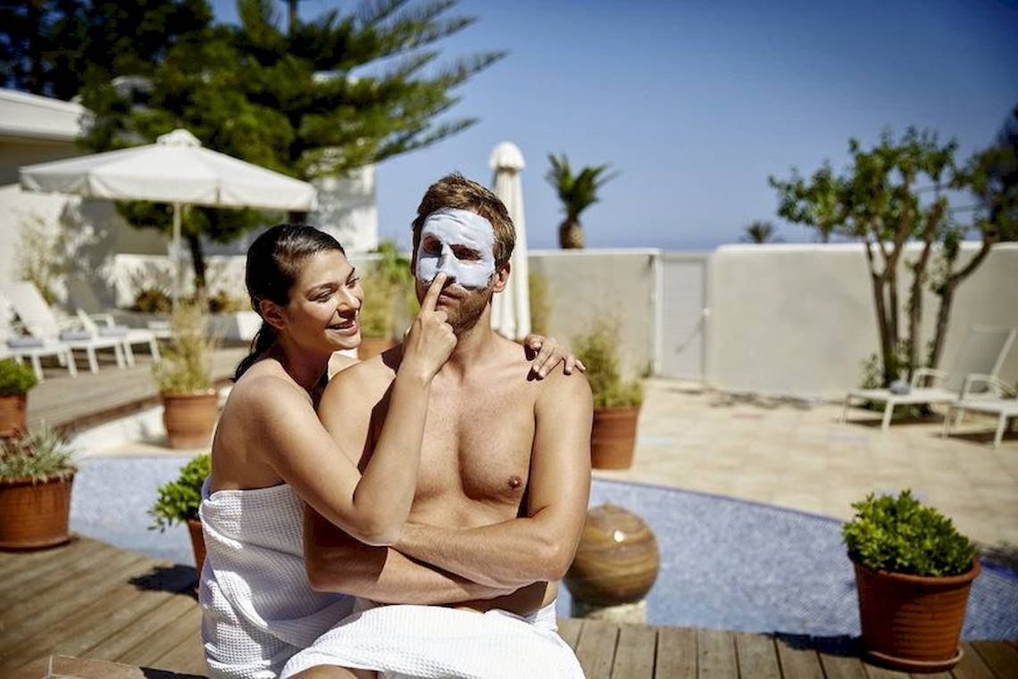 Ein Paar im Robinson Kyllini Beach Hotel genießt eine Gesichtsmaske auf der Terrasse.