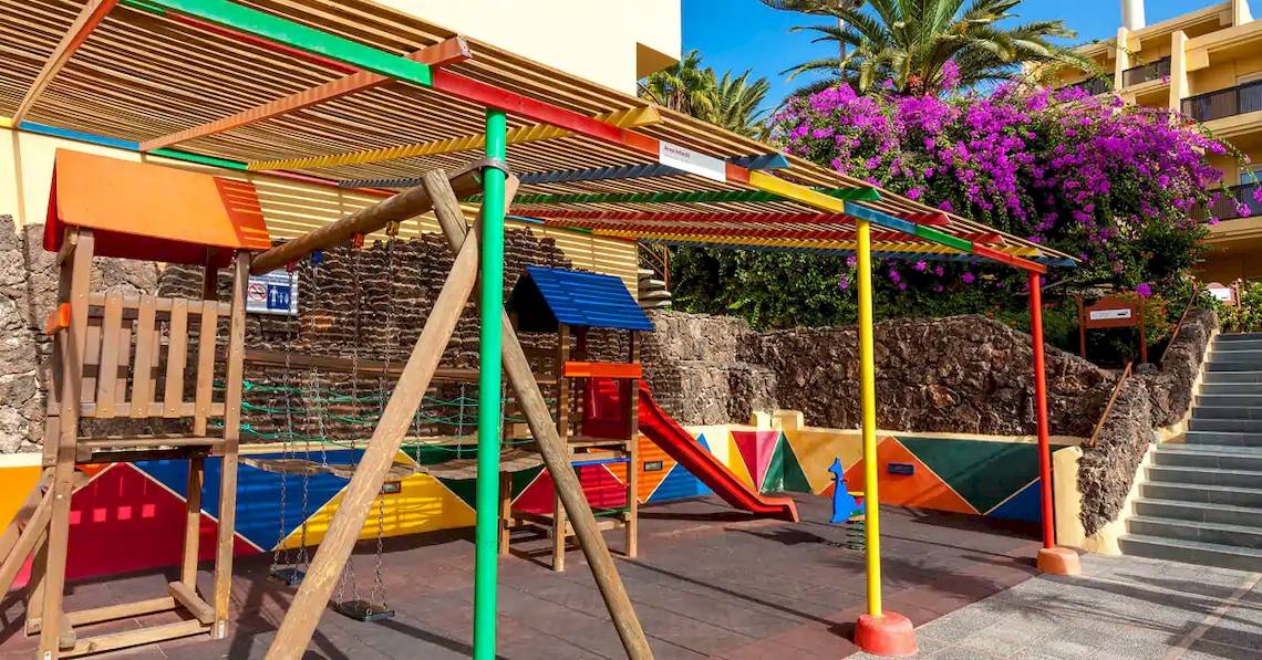 Farbig gestalteter Spielplatz im Sol Fuerteventura Jandia Hotel mit Rutsche und Schaukeln