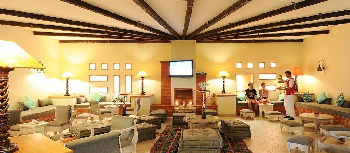 Loungebereich des Djerba Resorts mit Sofas, Tischen und Fernseher.