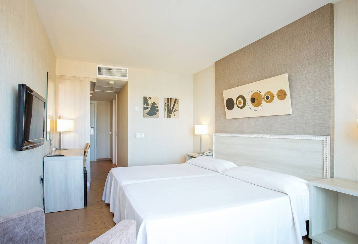 Innenansicht eines Zimmers im Be Live Experience Lanzarote Beach Hotel mit zwei Betten und modernen Möbeln.