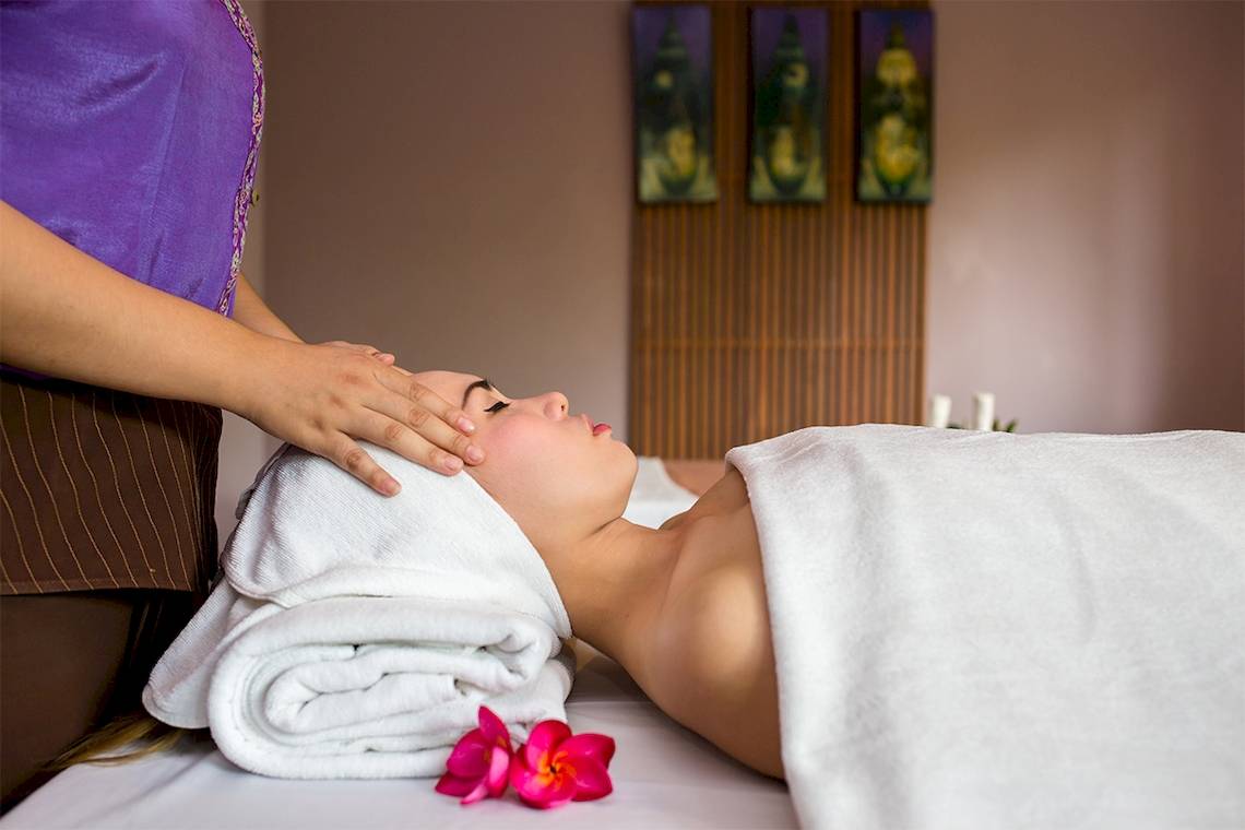 Eine Frau genießt eine Gesichtsmassage im Fair House Beach Resort.