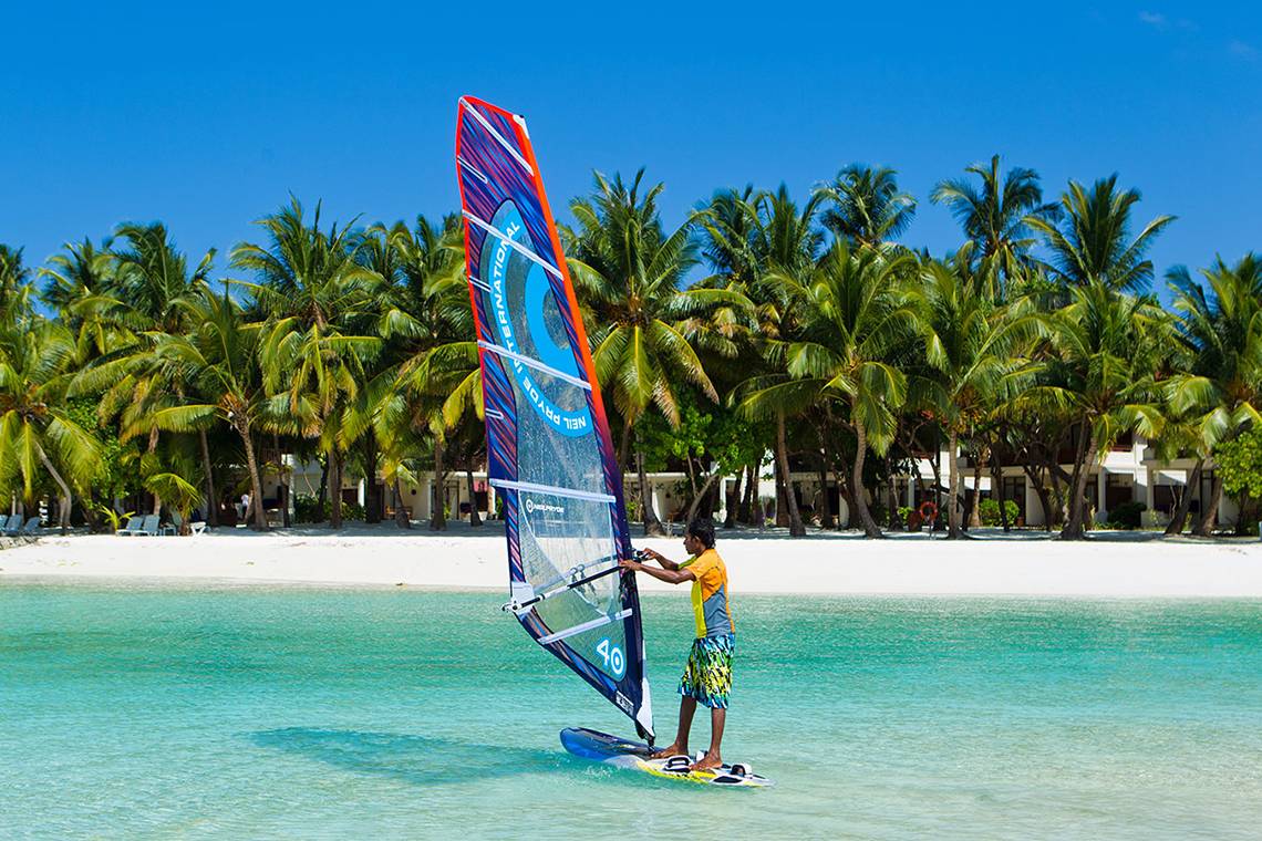 Windsurfer am Strand vor dem Kurumba Maldives Hotel