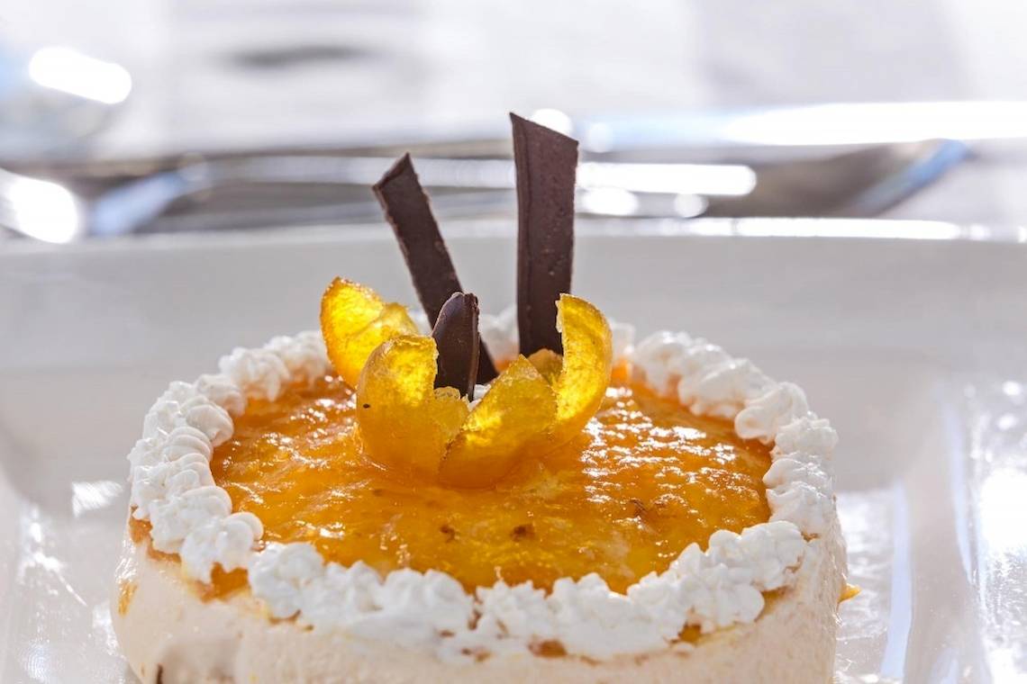 Dessert im Aeolos Beach Resort auf Korfu mit weißer Creme und orangen Stücken.