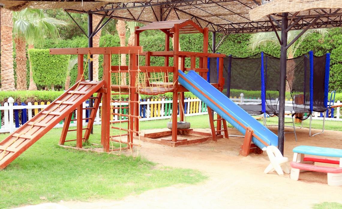 Spielplatz im Freien im LABRANDA Royal Makadi Hotel mit Rutsche und Klettergerüst.