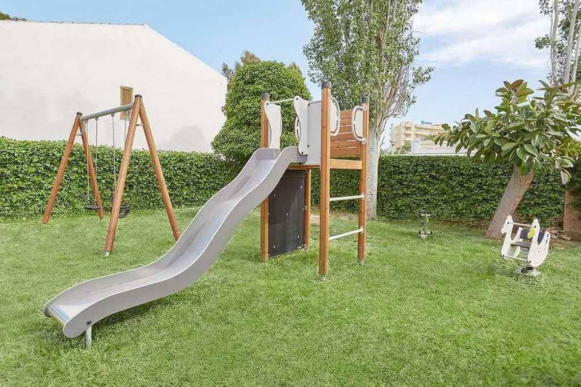 Kinderspielplatz im Hotel Universal Aparthotel Elisa mit einer Rutsche und einer Schaukel