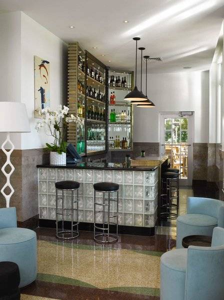 Innenansicht der Bar im Victor South Beach Hotel mit Theke, Stühlen und Dekor.