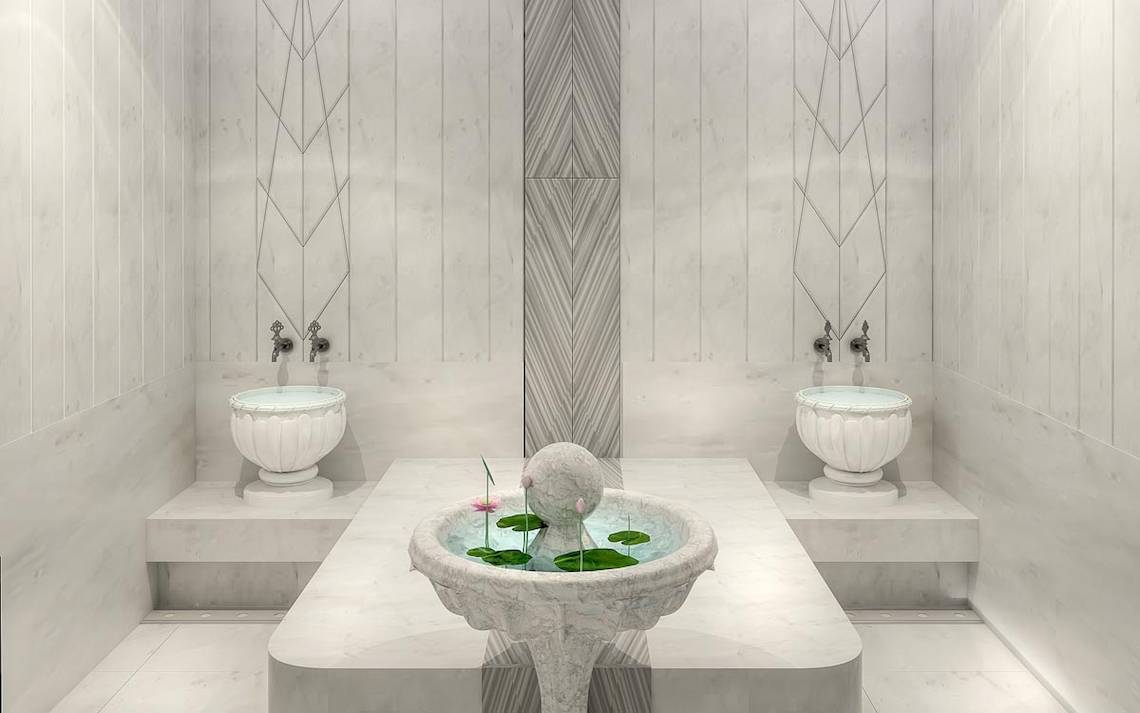 Innenbereich des Lago Hotels mit zwei Brunnen und Sitzbereichen in Marmor