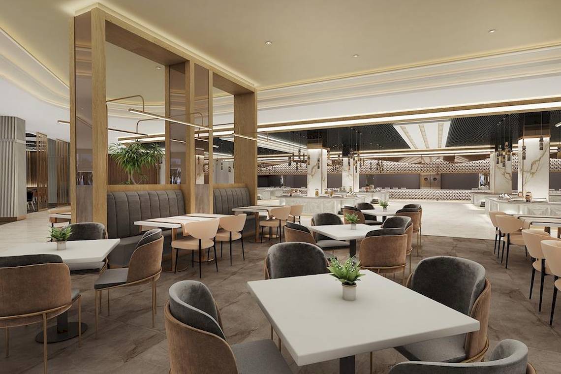 Das Interieur des Lago Hotels zeigt ein modernes Restaurant mit weißen Tischen und Stühlen.
