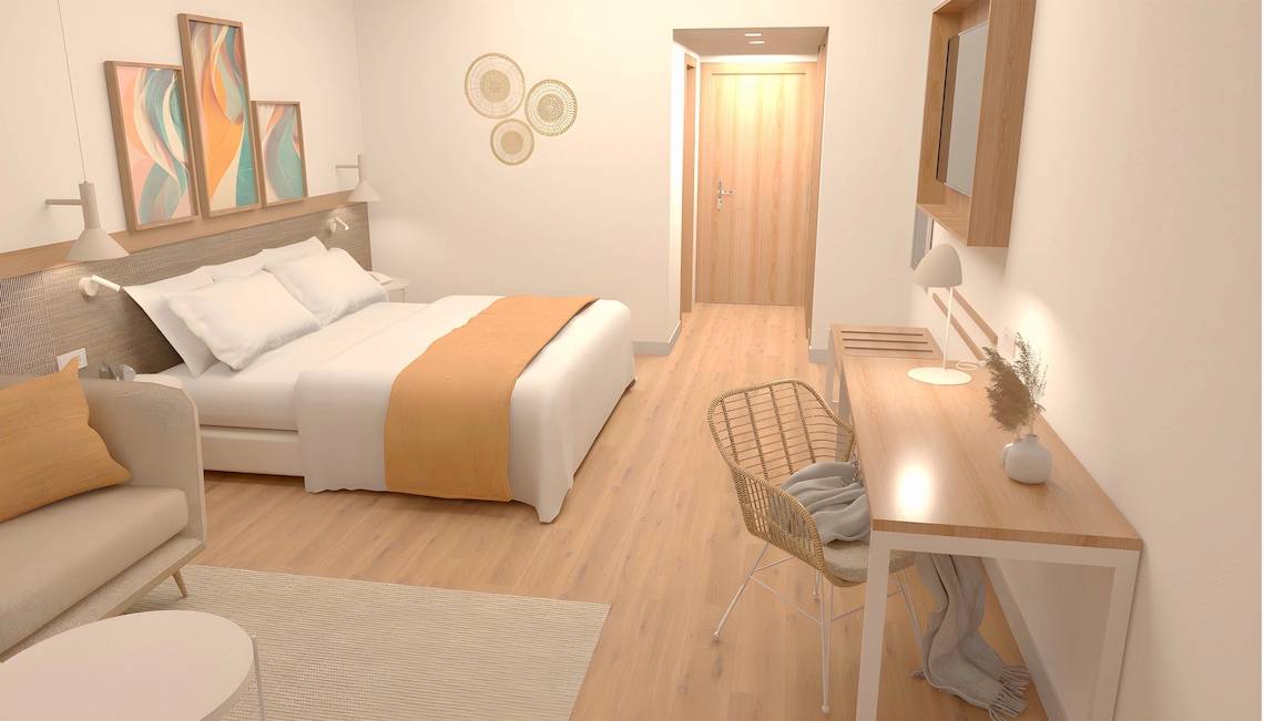 Innenansicht eines Hotelzimmers im Sunscape Dominicus La Romana, mit Bett, Schreibtisch und Wohnzimmermöbeln.