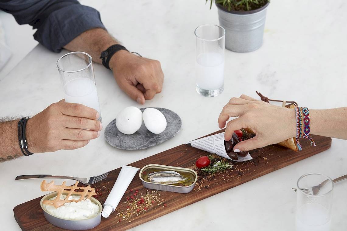 Frühstückstisch im Archipelagos Hotel mit Sardine und Eiern auf einem Holzbrett