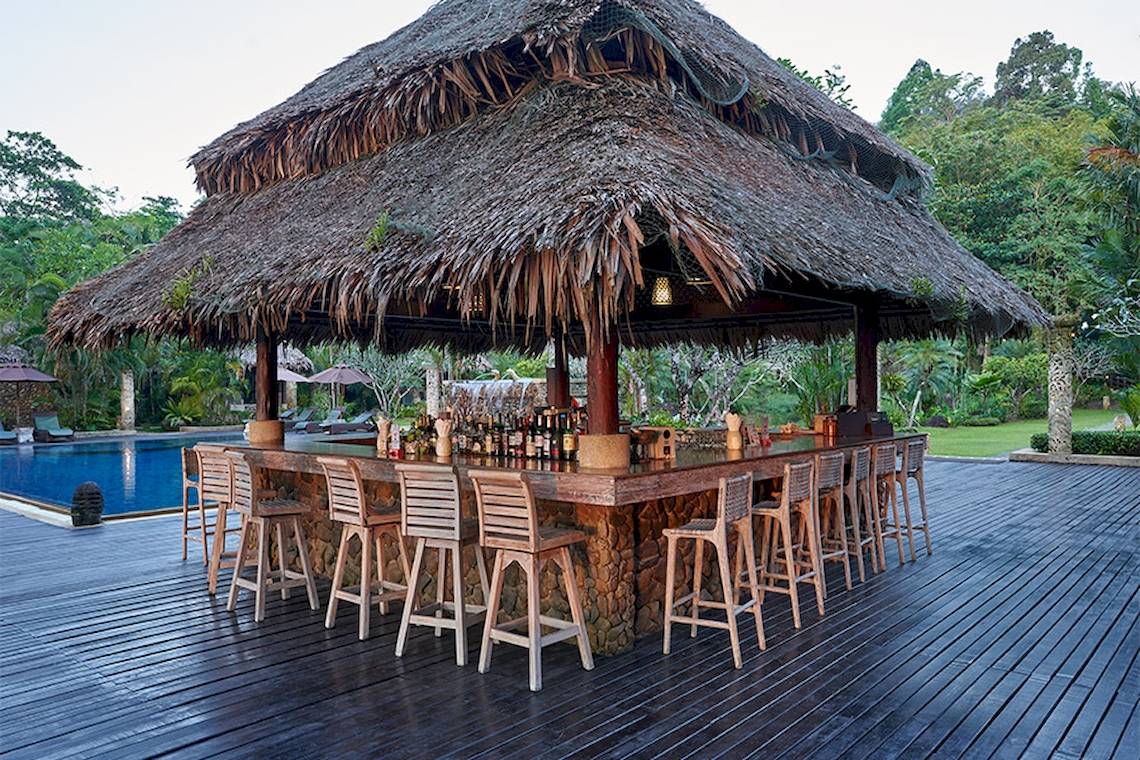 Bar im Khaolak Paradise Resort mit Blick auf den Pool und einer Strohdach-Überdachung.