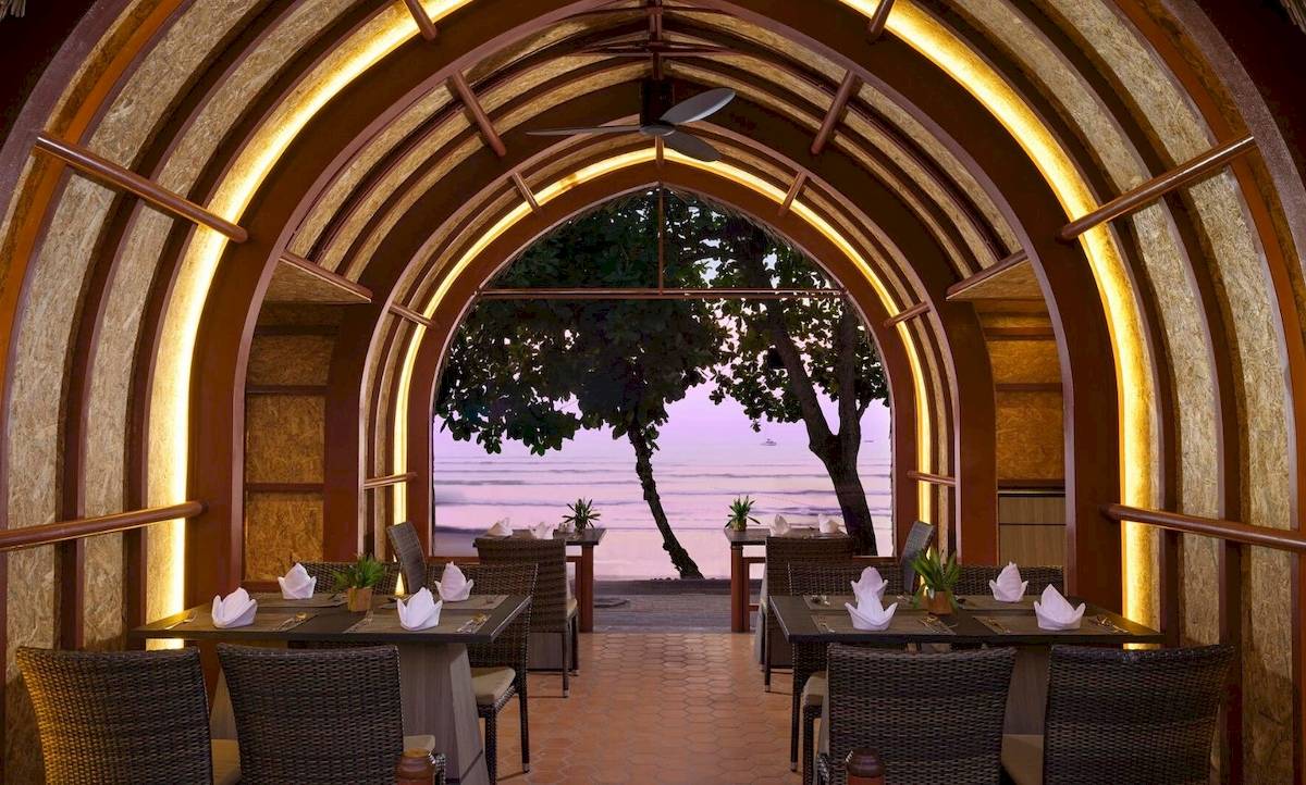 Innenbereich des Aonang Villa Resorts, Restaurantbereich mit Blick auf den Ozean am Abend.