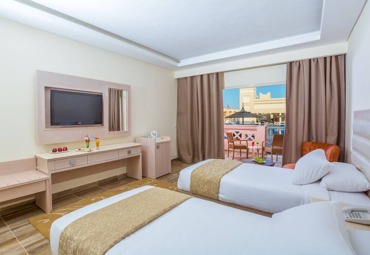 Doppelzimmer im Pickalbatros Aqua Vista Resort mit zwei Betten, Fernseher und Balkon.