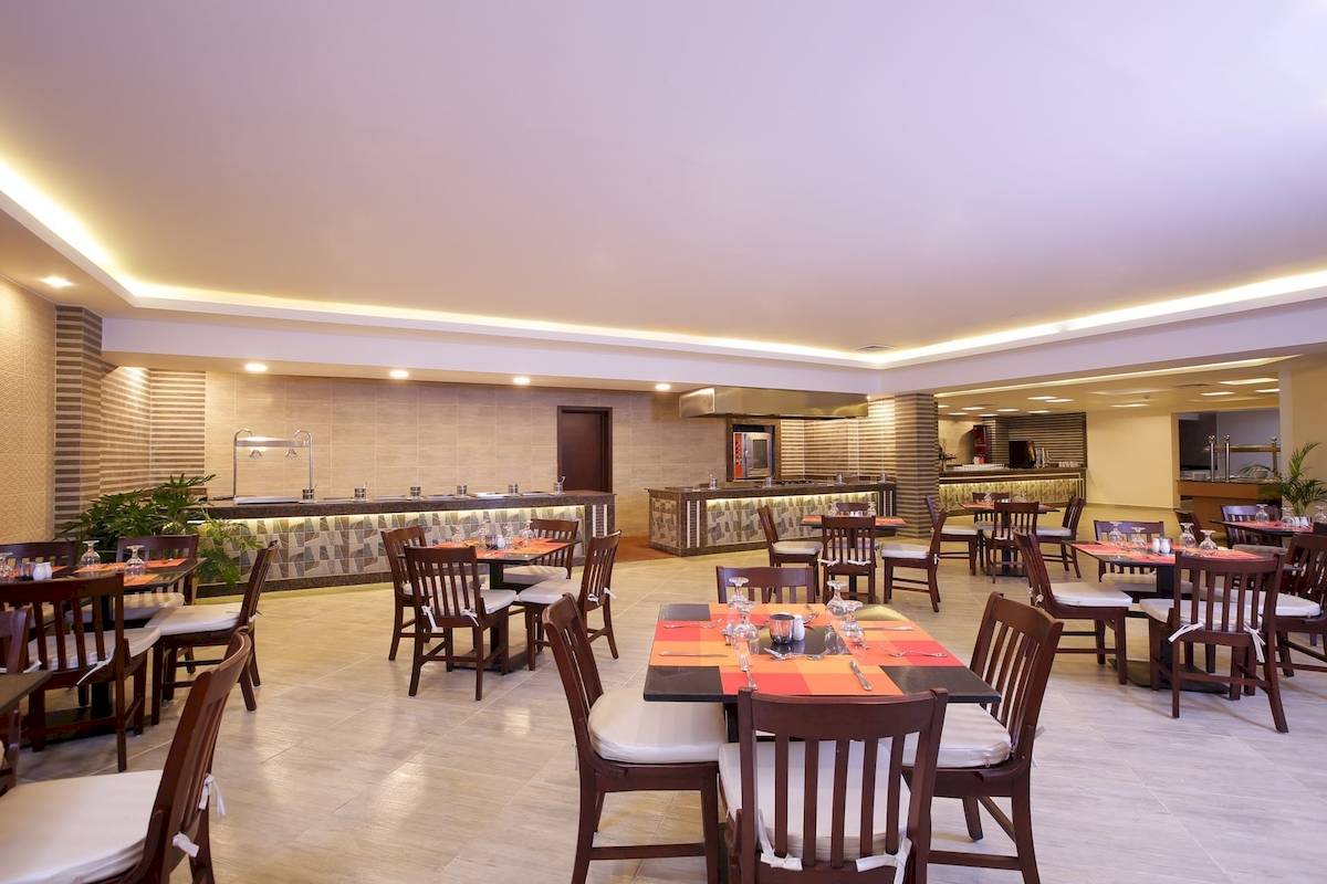 Innenansicht des Restaurants im Pickalbatros Aqua Vista Resort mit mehreren Tischen und Stühlen.