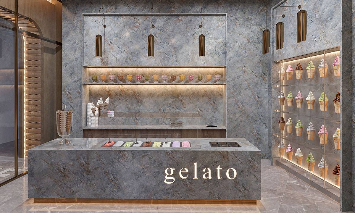 Innenansicht des Gelato-Bars im Gloria Serenity Resort mit marmornen Wänden und einer Theke voller Eisbecher.