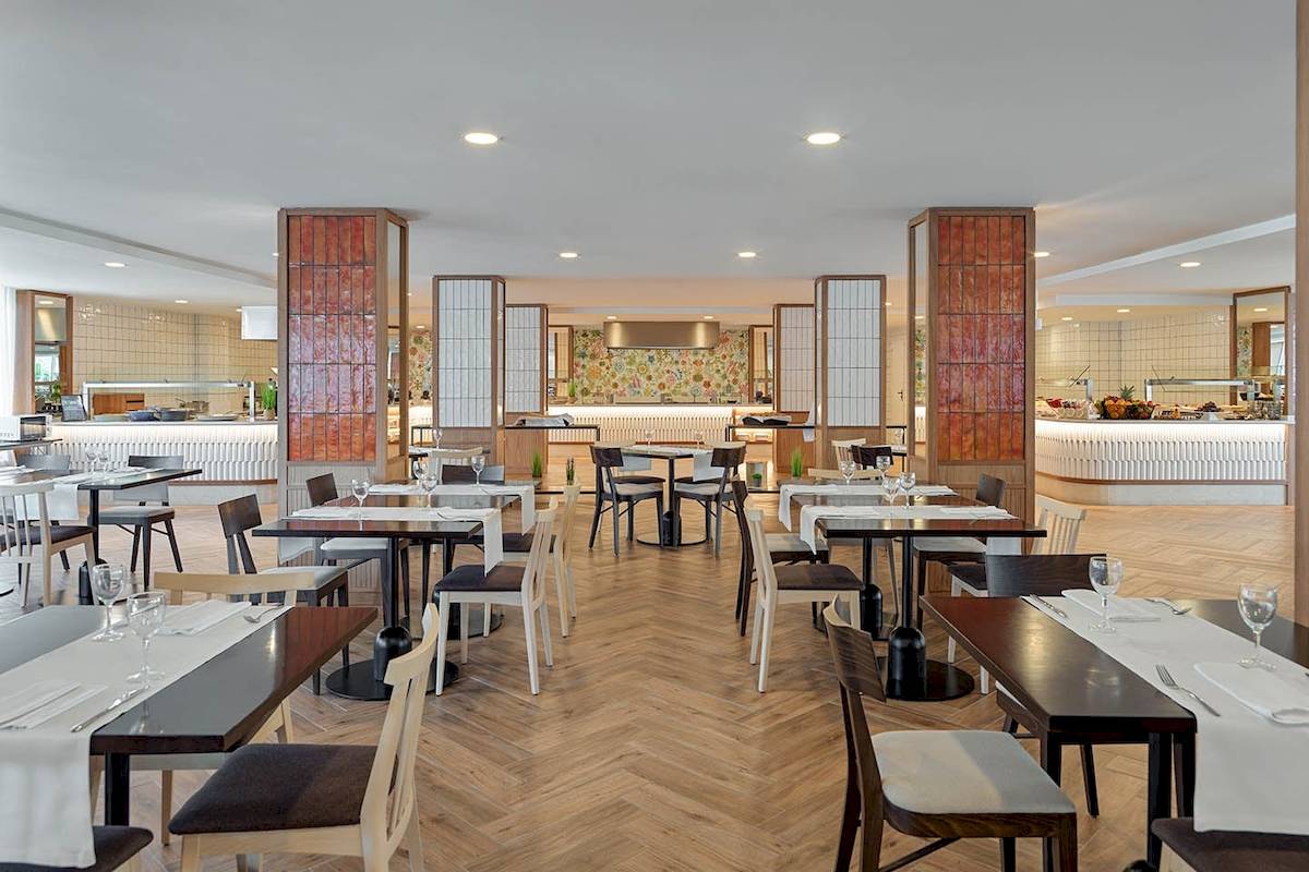 Innenansicht des Restaurants des H10 Casa del Mar Hotels mit geometrischen Säulen und Holzboden.
