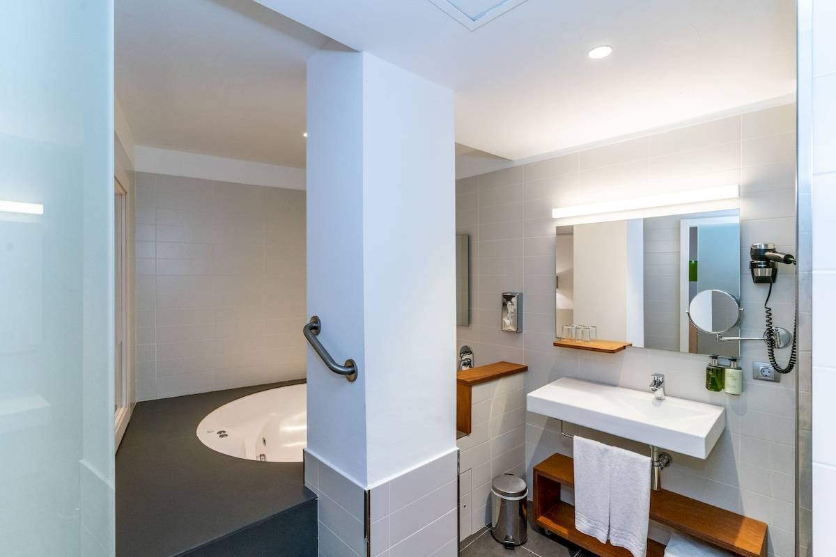 Badezimmer im ARTIEM Audax Hotel mit Badewanne und Spiegelschrank