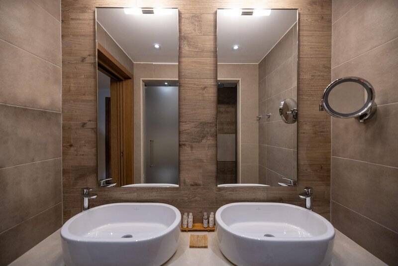 Badezimmer im Miraggio Thermal Spa Resort mit zwei Waschbecken und Spiegeln