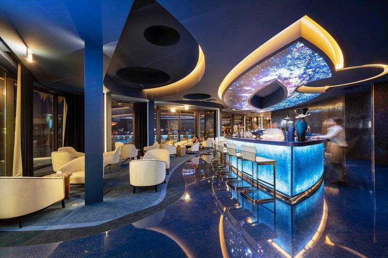 Innenansicht der Savoy Palace Hotel Bar mit blauem Boden und modernen Möbeln.