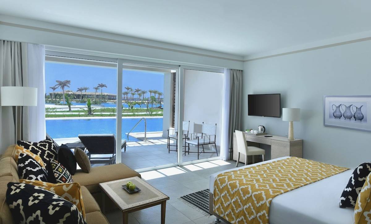 Modernes Hotelzimmer mit großer Glasfront und Poolblick im Steigenberger Resort Alaya.
