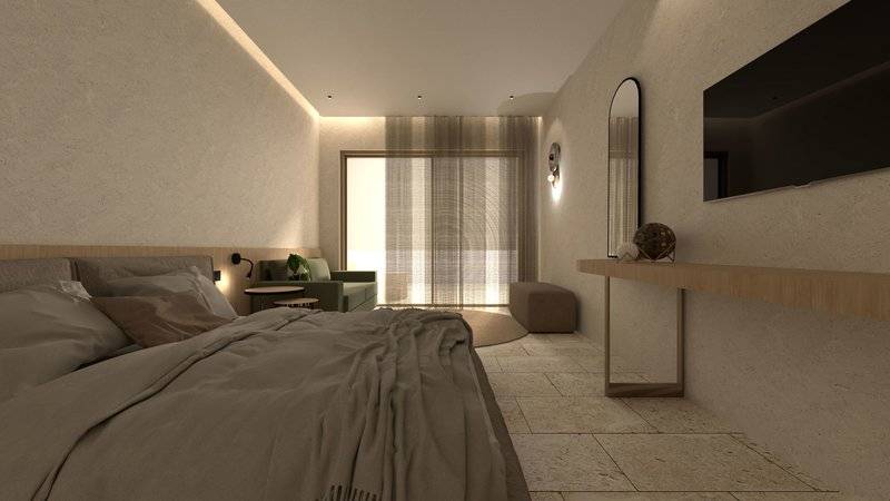 Innenansicht eines Schlafzimmers im Alexandra Beach Resort mit Doppelbett, Couch, Fernseher und Tisch