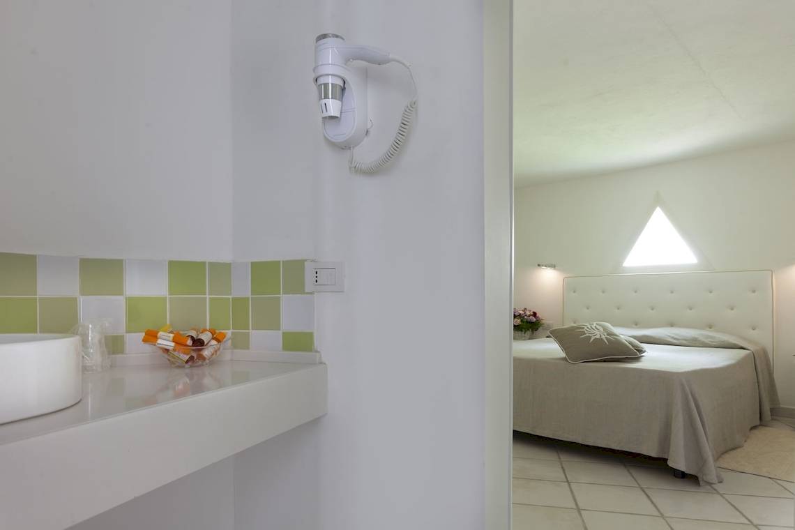 Hotelzimmer des Mare Pineta mit Bett und Bad, Blick durch Spiegel