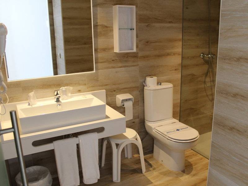 Badezimmer im R2 Veronica Beach Hotel mit Waschbecken, Toilette und Dusche.