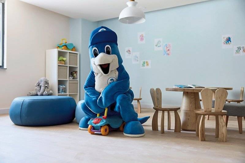 Kinderzimmer mit blauem Spielzeugauto und blauem Plüschtier in einem Hotel