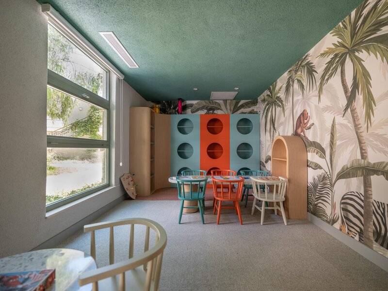 Kinderzimmer im Sherwood Exclusive Kemer Hotel mit farbenfrohen Möbeln und tropischem Wandbild.