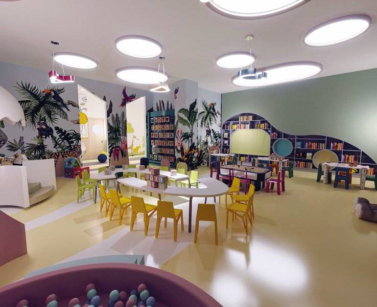 Kinderspielzimmer im Arcanus Hotels Trendline Side mit bunten Möbeln und Bücherregalen.