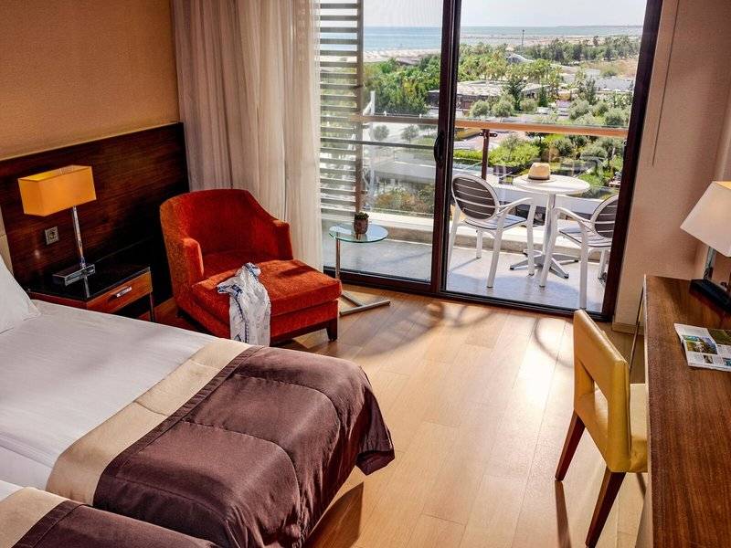 Zimmer im TUI BLUE Side Hotel mit Blick auf einen Balkon und Meer.