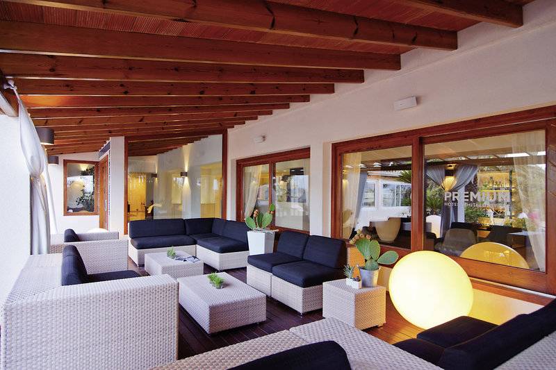 Lounge Bereich im Tahiti Hotel mit weißen Möbeln, Holzdecke und großen Fenstern.