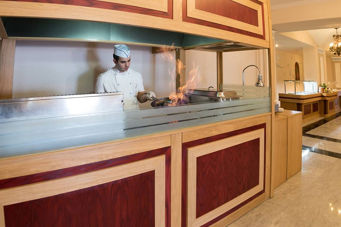 Koch im Eliros Mare Hotel Restaurant brät mit Feuer