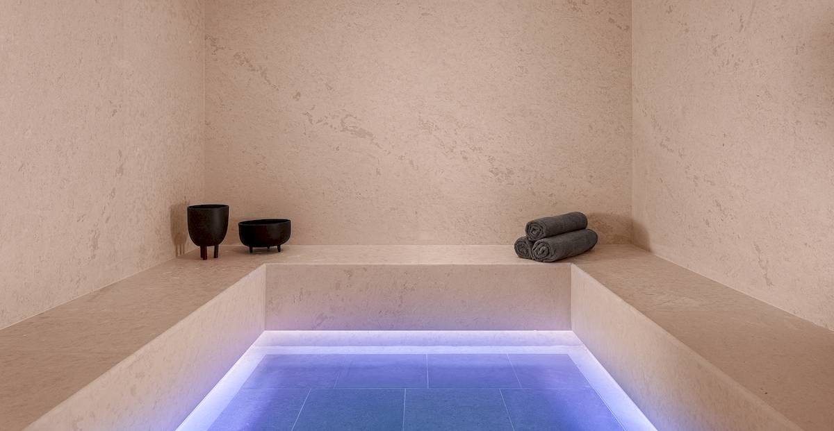 Dampfbad im Helea Lifestyle Beach Resort mit blau beleuchtetem Boden und zwei schwarzen Bechern