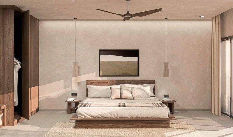 Innenansicht des Schlafzimmers im Aldiana Club Naga Bay mit Doppelbett, Holzschrank und Deckenventilator.
