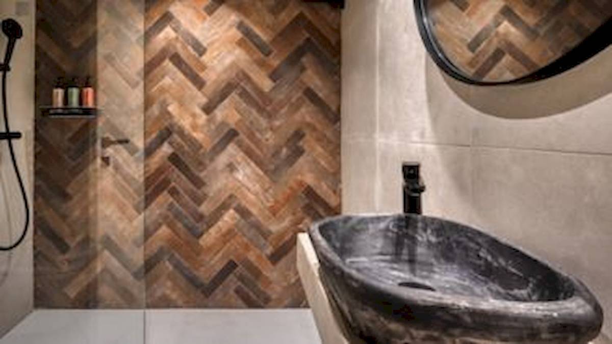 Badezimmer mit braunem Holz-Herzmuster an der Wand und einer schwarzen Marmor-Waschbecken.