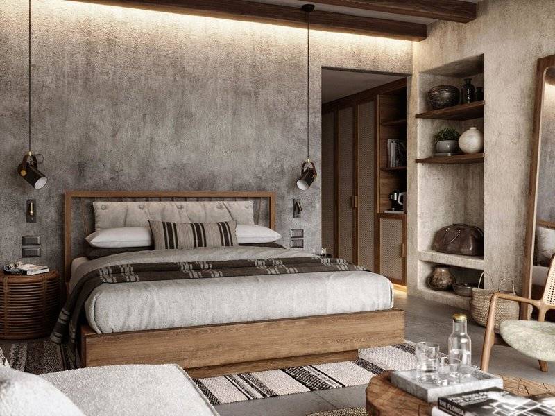 Schlafzimmer im JAZ Riviera Hotel mit Betonwand, Holzbett, Kissen und hängenden Lampen.