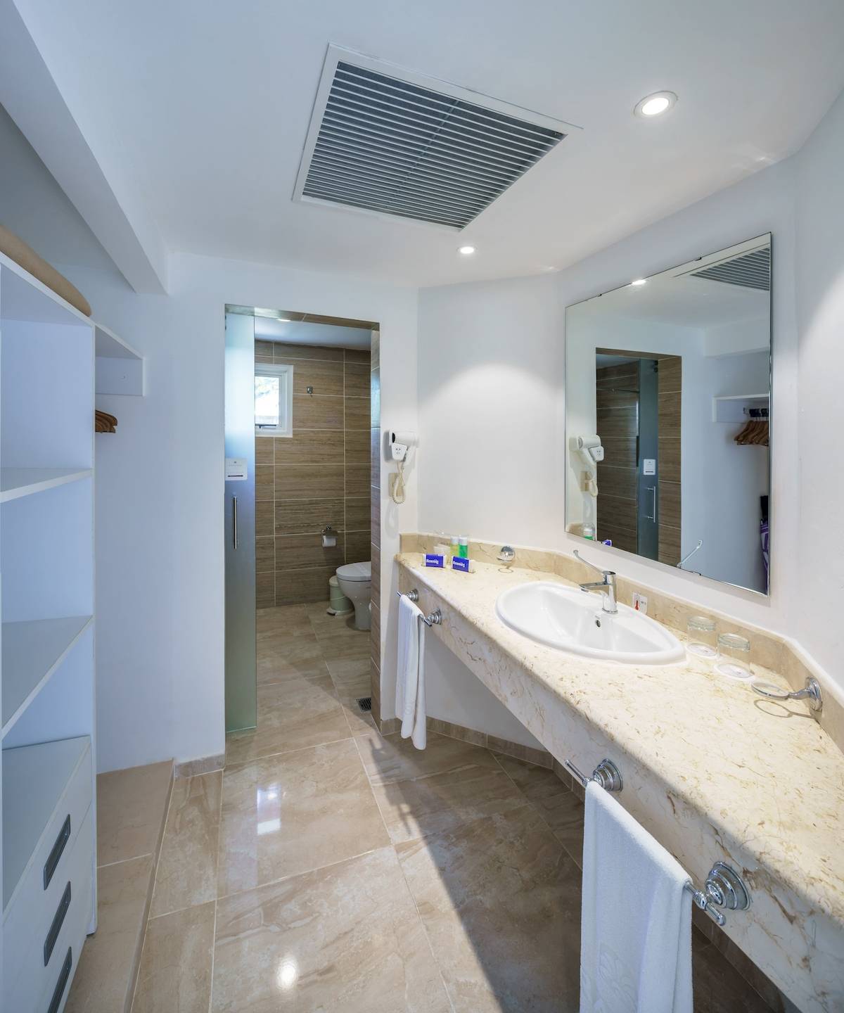 Badezimmer im Paradisus Varadero Resort & Spa mit luxuriöser Einrichtung, großer Spiegel und Marmorarbeitsplatte.