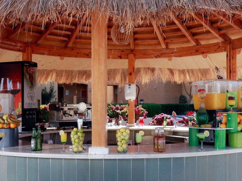 Cocktailbar des Lemon & Soul Garden Makadi Hotels unter einem runden Strohdach.