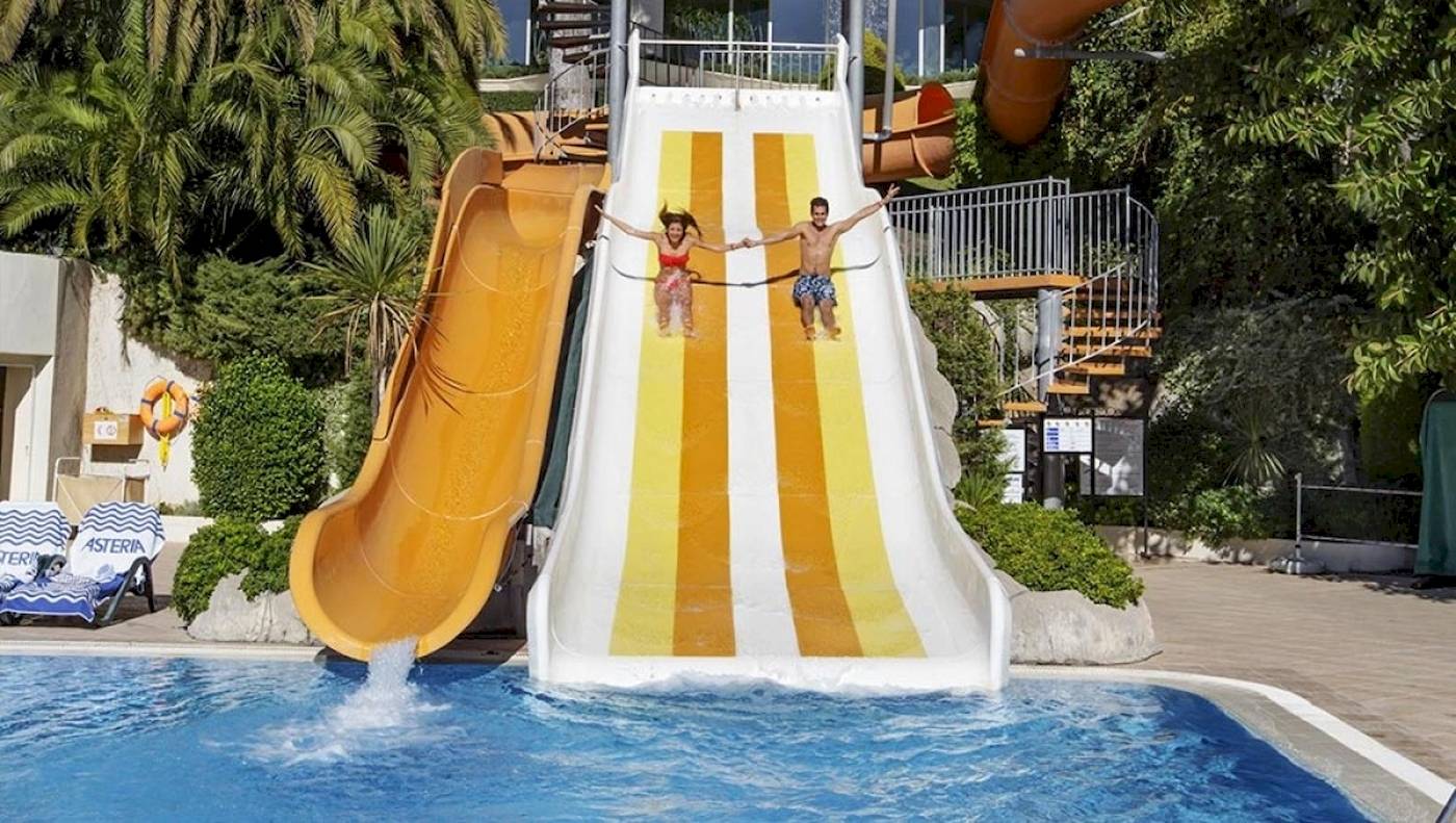 Zwei Leute rutschen im Wasserpark des Side Star Elegance Hotels.