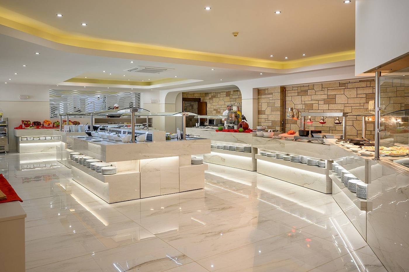 Buffetbereich im Vantaris Palace Hotel mit weißen Marmortischen und verschiedenen Speisen.