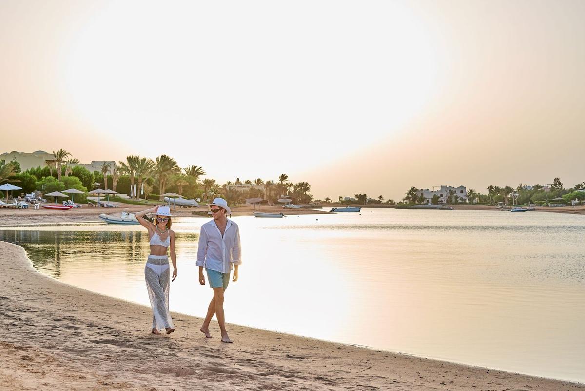 Paar am Strand des Three Corners Rihana Resorts bei Sonnenuntergang