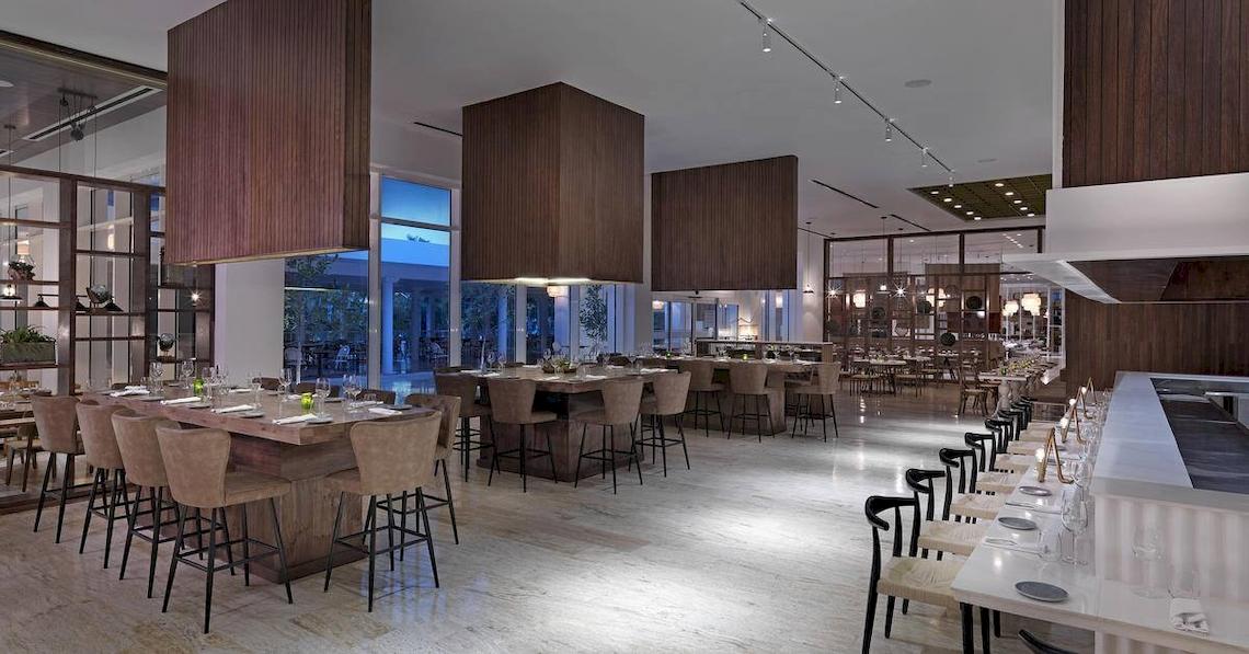 Innenansicht des Restaurants im Melia Caribe Beach Resort mit Holzelementen und runden Tischen.