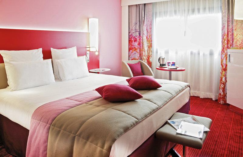 Hotelzimmer im Mercure Paris Montmartre Sacré-Coeur mit Bett, Kissen und Möbeln