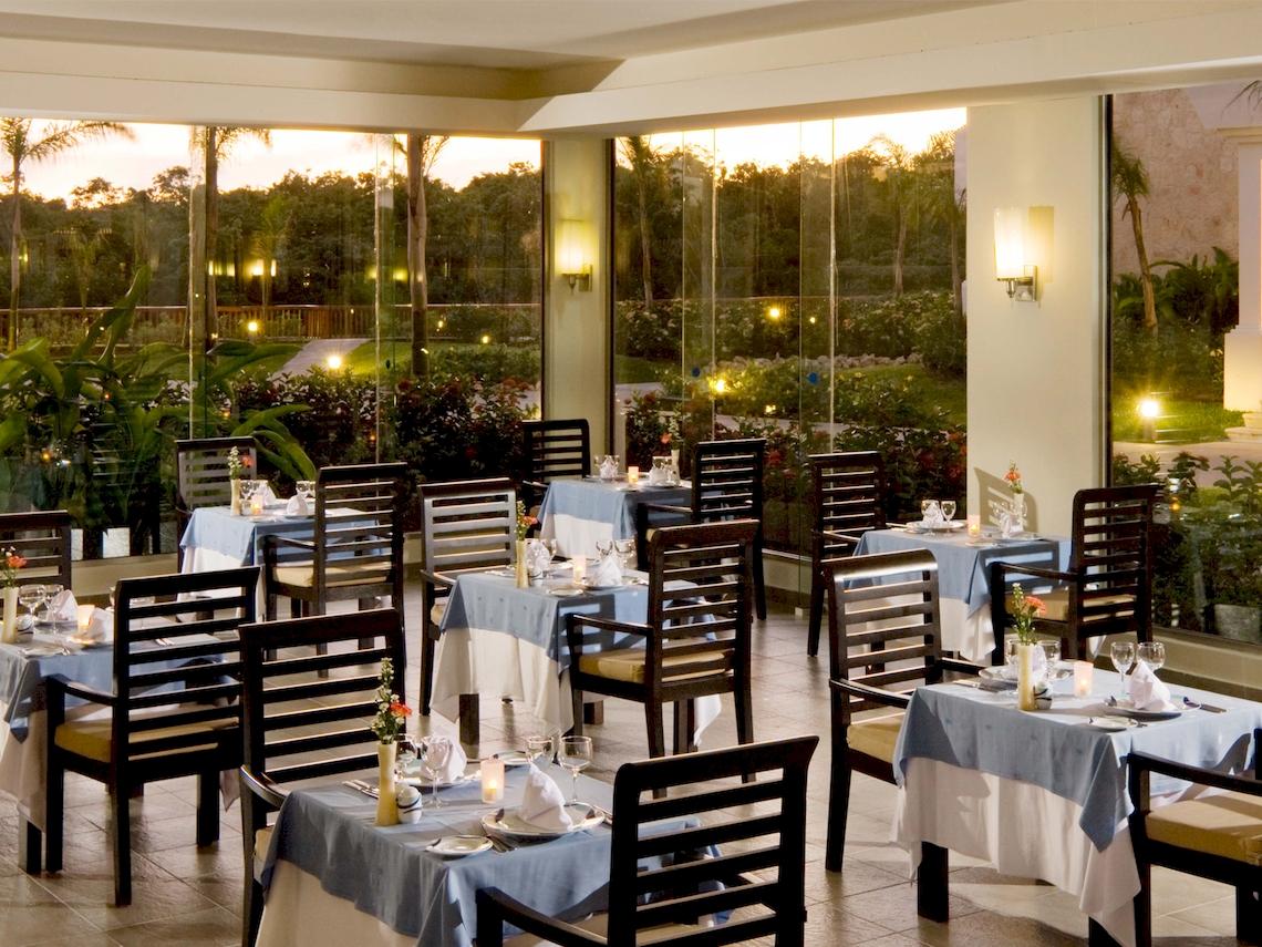 Innenansicht des Restaurants im Grand Sunset Princess All Suites Resort mit Blick auf den Garten.