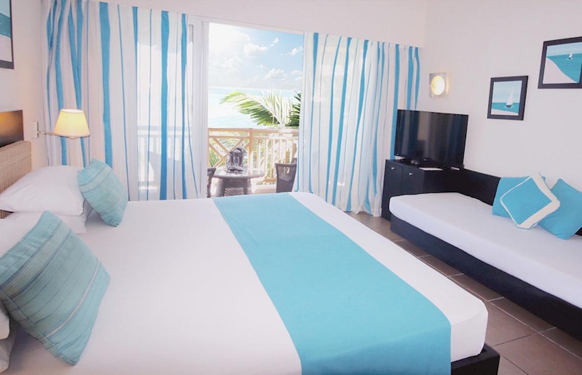 Ein modernes Hotelzimmer im Pearle Beach Resort & Spa mit Blick auf das Meer.