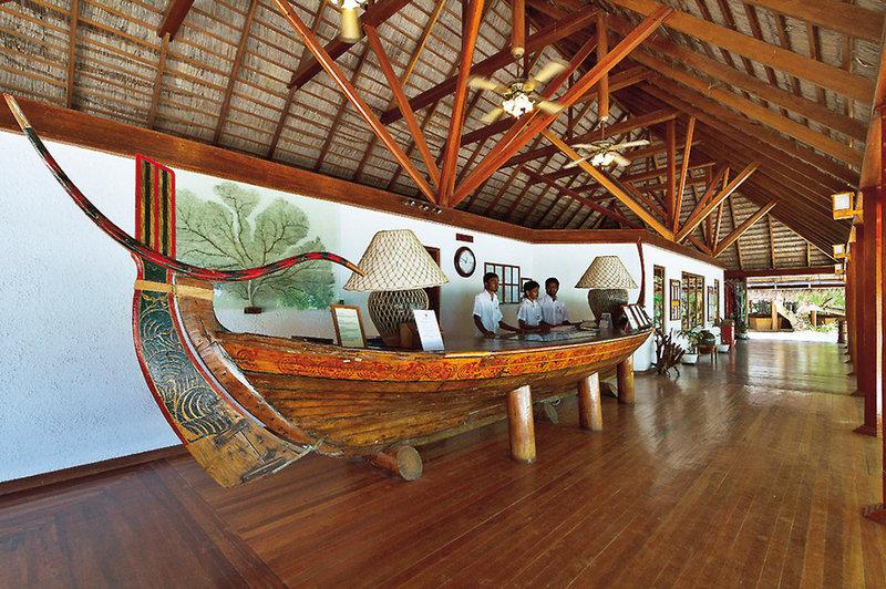 Lobby des Nakai Maayafushi Resorts mit einem großen dekorierten Boot am Empfang.