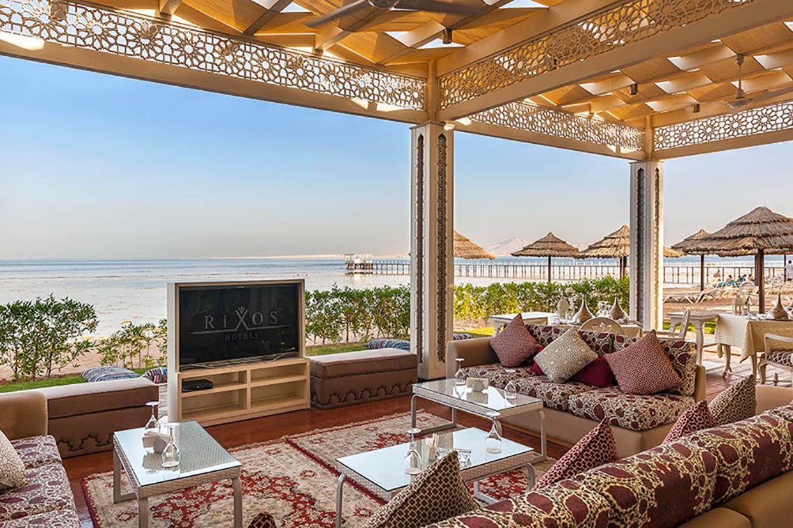 Loungebereich des Rixos Sharm El Sheikh Hotels mit Blick auf das Meer und eine Terrasse.