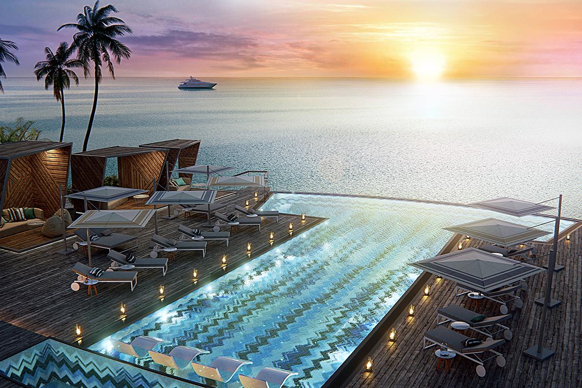 Pool-Aussicht des JW Marriott Maldives Resort & Spa mit Lounge-Liegen und Palmen